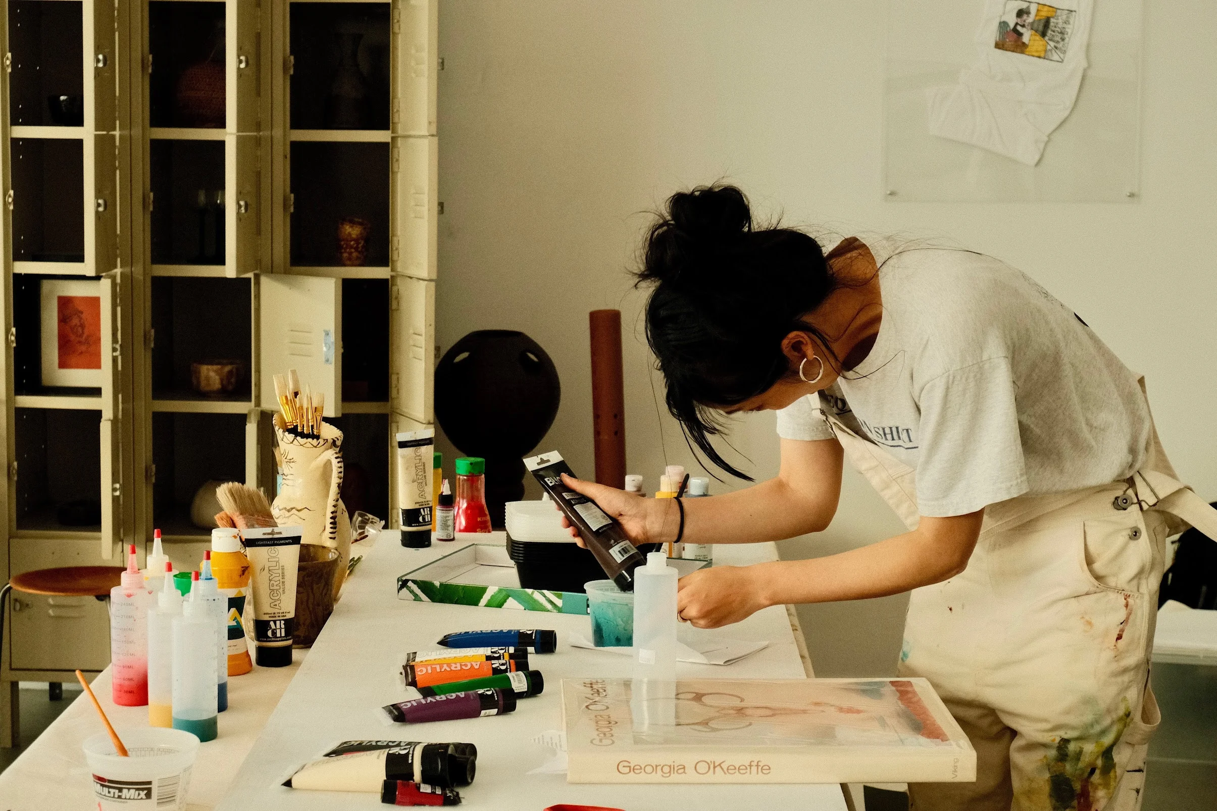 Interact Studio's July resident, artist and curator Holly Li, at work in the studio.